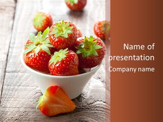 A Bowl Of Strawberries On A Wooden Table PowerPoint Template