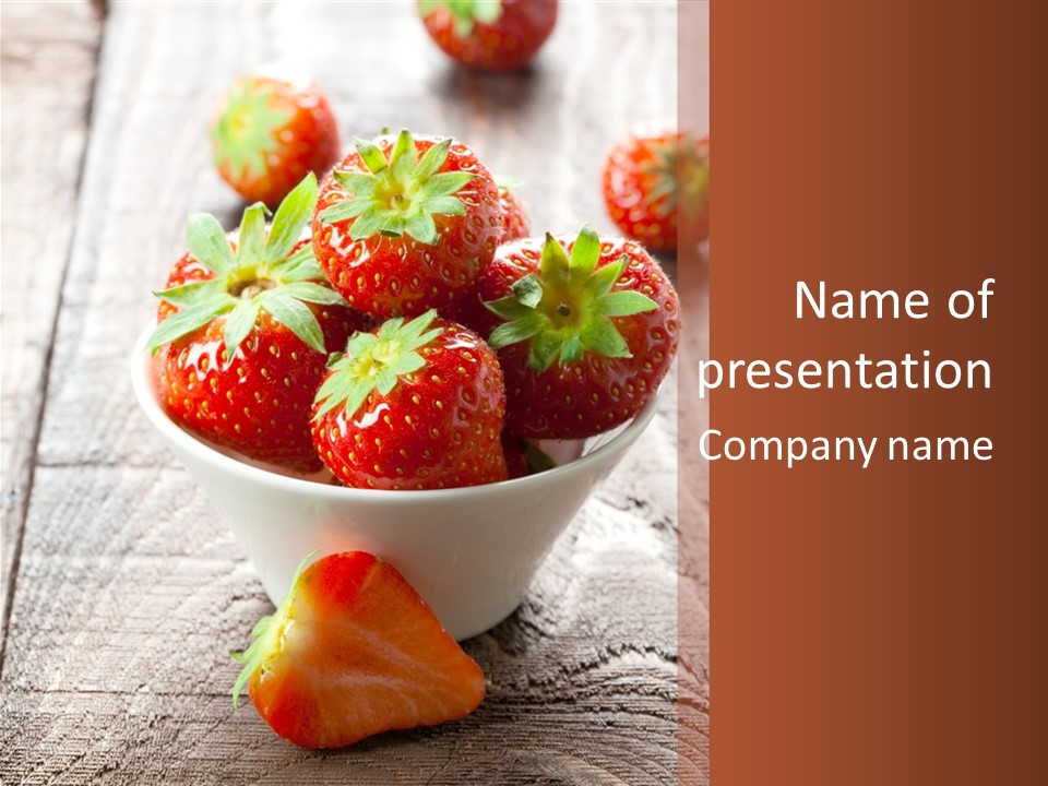 A Bowl Of Strawberries On A Wooden Table PowerPoint Template