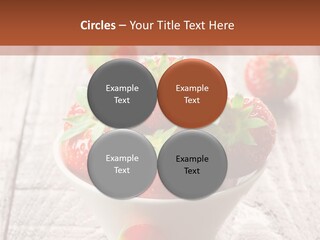 A Bowl Of Strawberries On A Wooden Table PowerPoint Template