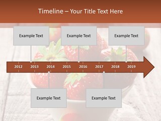 A Bowl Of Strawberries On A Wooden Table PowerPoint Template