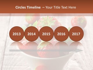 A Bowl Of Strawberries On A Wooden Table PowerPoint Template