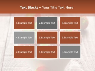 A Bowl Of Strawberries On A Wooden Table PowerPoint Template