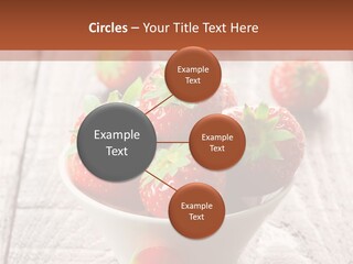 A Bowl Of Strawberries On A Wooden Table PowerPoint Template