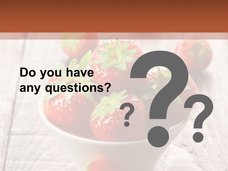 A Bowl Of Strawberries On A Wooden Table PowerPoint Template