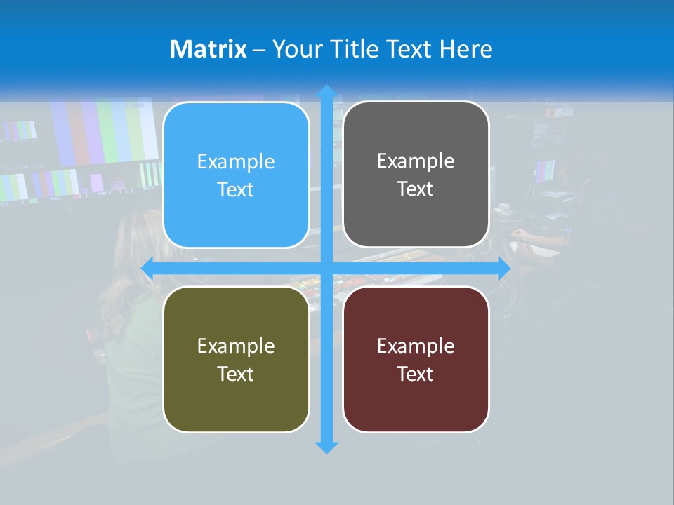 A Group Of People Sitting At A Desk With Computers PowerPoint Template