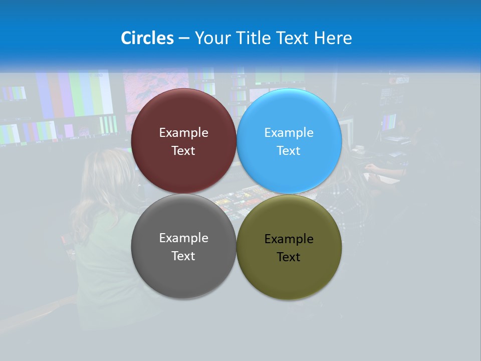 A Group Of People Sitting At A Desk With Computers PowerPoint Template