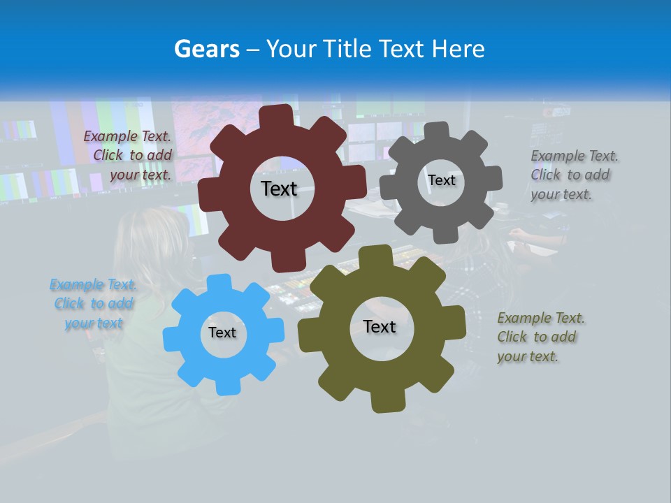 A Group Of People Sitting At A Desk With Computers PowerPoint Template