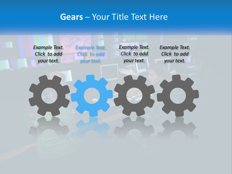 A Group Of People Sitting At A Desk With Computers PowerPoint Template