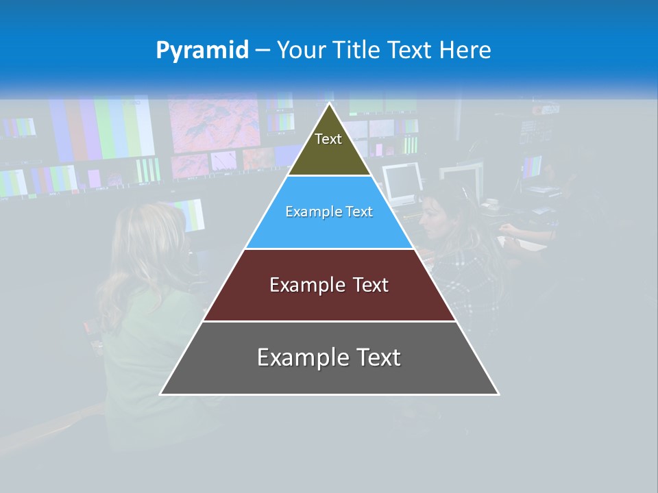 A Group Of People Sitting At A Desk With Computers PowerPoint Template