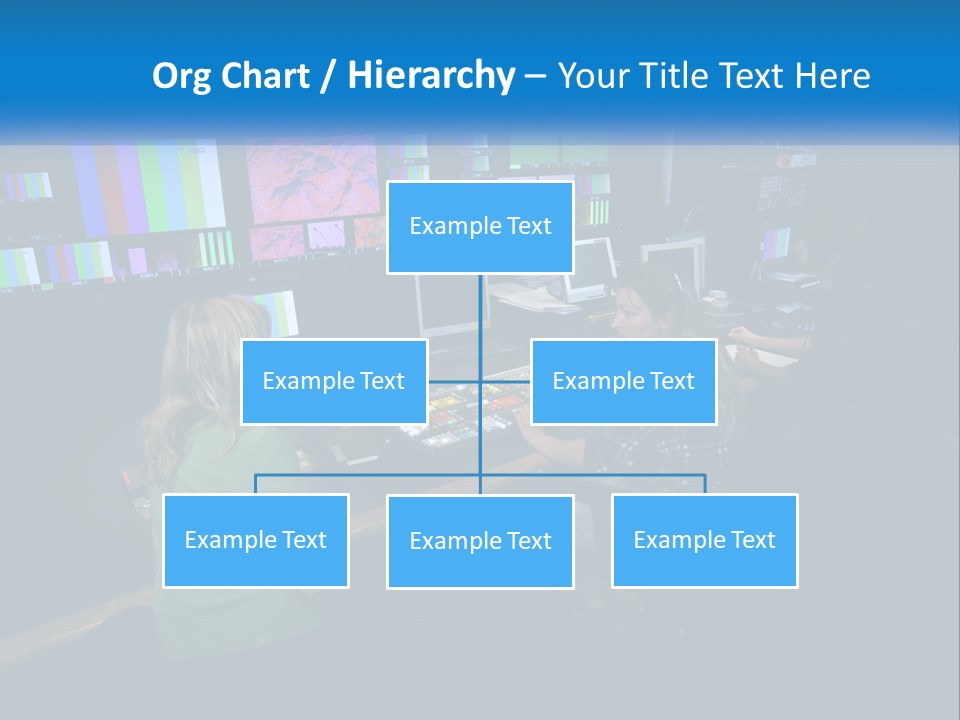 A Group Of People Sitting At A Desk With Computers PowerPoint Template