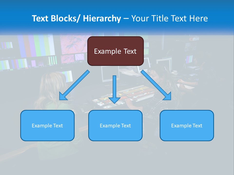 A Group Of People Sitting At A Desk With Computers PowerPoint Template