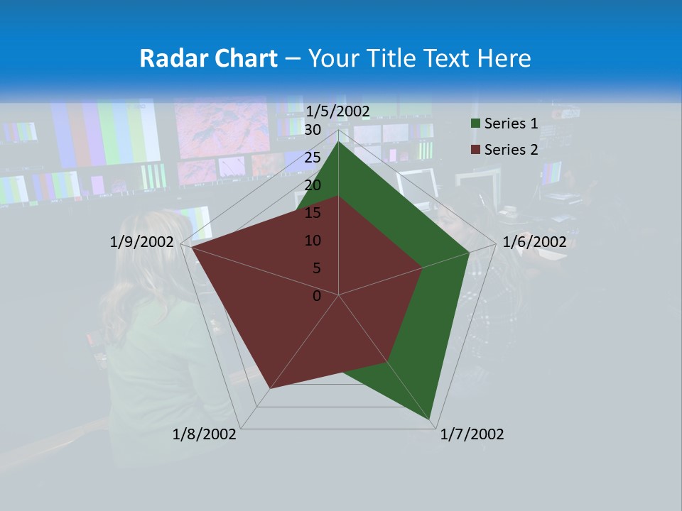 A Group Of People Sitting At A Desk With Computers PowerPoint Template