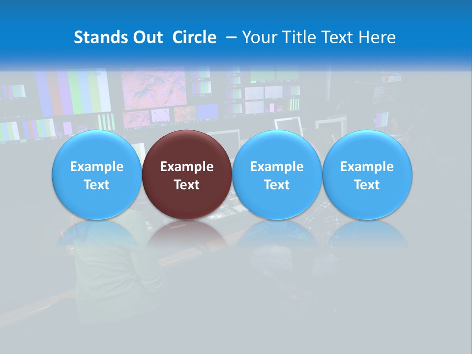 A Group Of People Sitting At A Desk With Computers PowerPoint Template