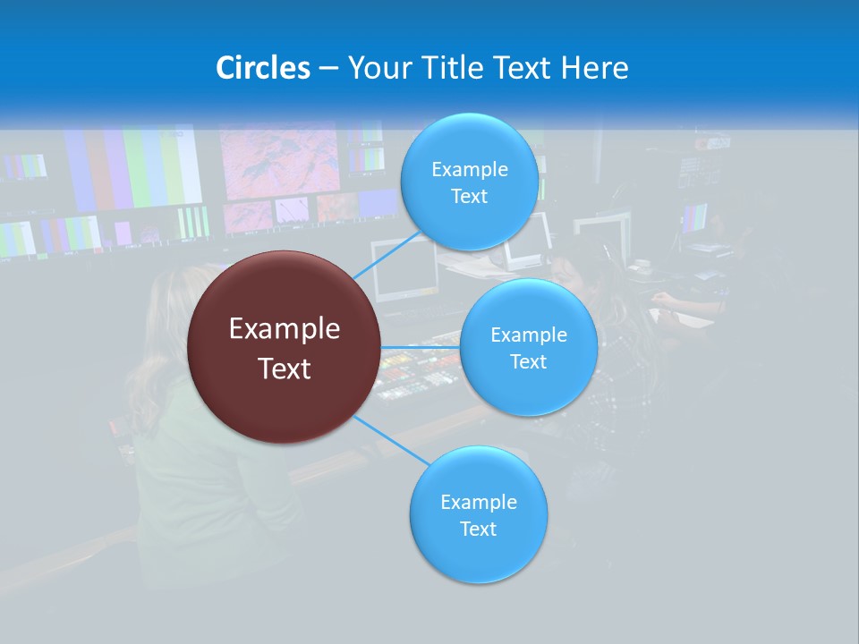 A Group Of People Sitting At A Desk With Computers PowerPoint Template