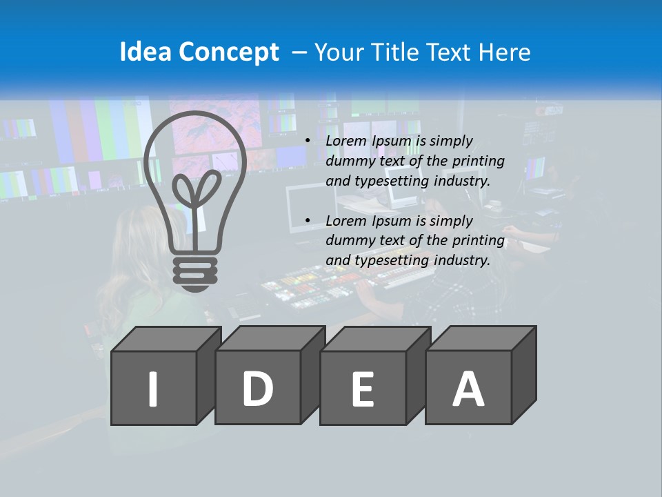 A Group Of People Sitting At A Desk With Computers PowerPoint Template