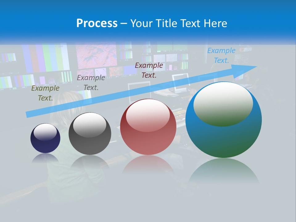 A Group Of People Sitting At A Desk With Computers PowerPoint Template