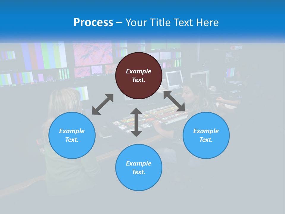 A Group Of People Sitting At A Desk With Computers PowerPoint Template