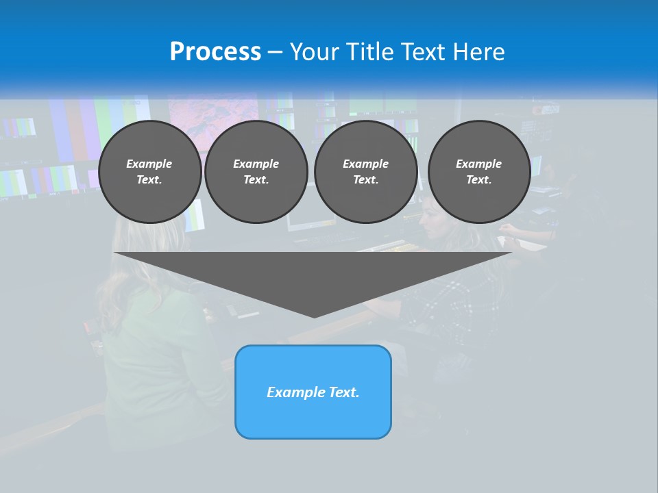 A Group Of People Sitting At A Desk With Computers PowerPoint Template
