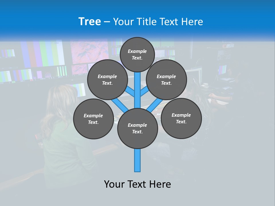 A Group Of People Sitting At A Desk With Computers PowerPoint Template
