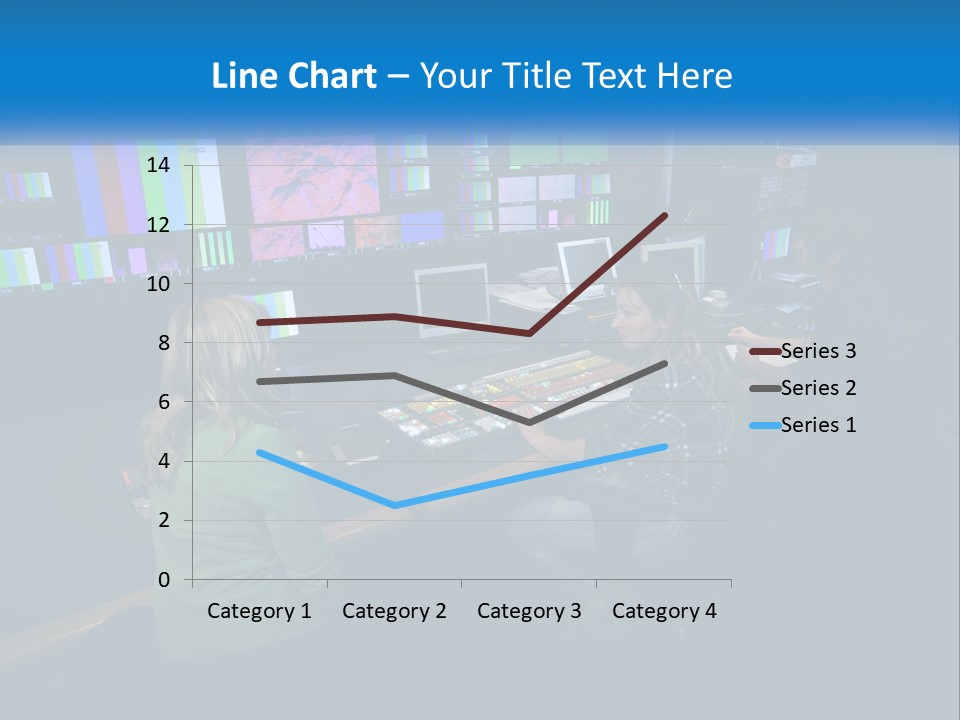 A Group Of People Sitting At A Desk With Computers PowerPoint Template