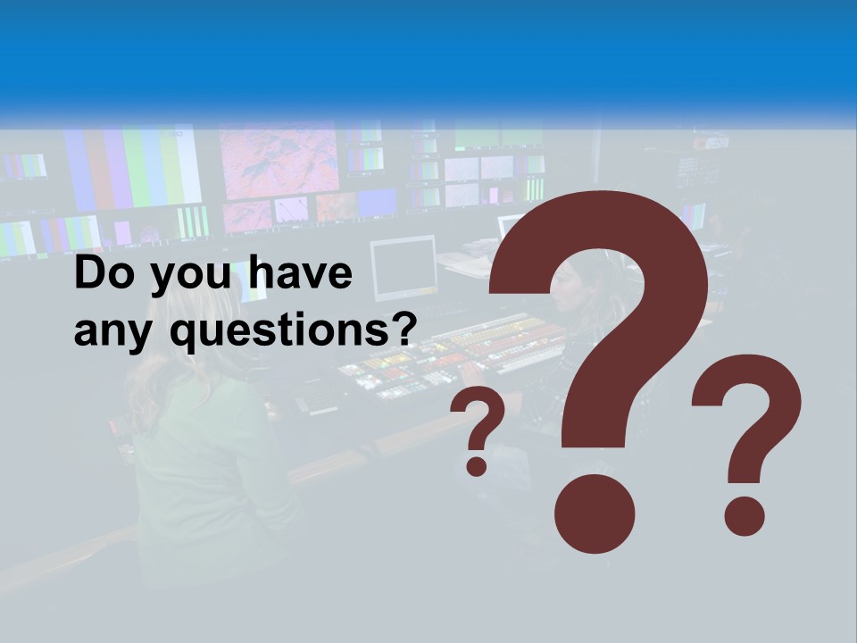 A Group Of People Sitting At A Desk With Computers PowerPoint Template