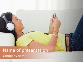 A Woman Laying On A Couch Listening To Music With Headphones PowerPoint Template