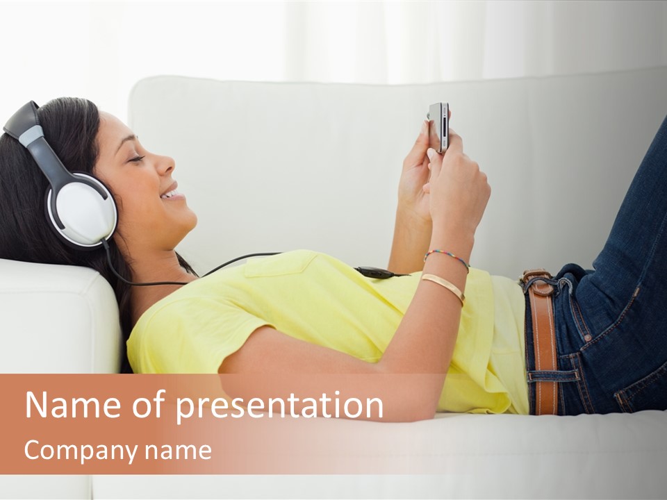 A Woman Laying On A Couch Listening To Music With Headphones PowerPoint Template