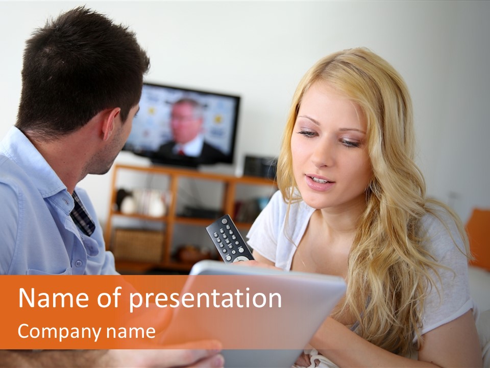 A Man And A Woman Sitting On A Couch Looking At A Remote Control PowerPoint Template