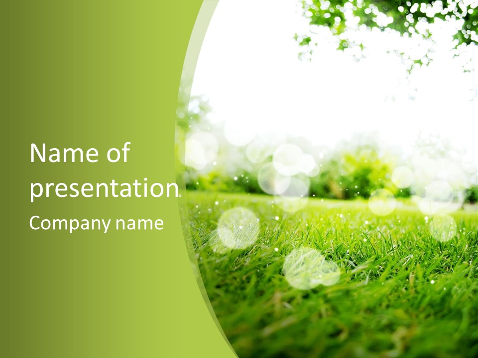 A Green Grass Field With A Tree In The Background PowerPoint Template