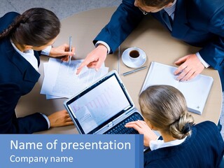 A Group Of People Sitting Around A Table Working On A Laptop PowerPoint Template