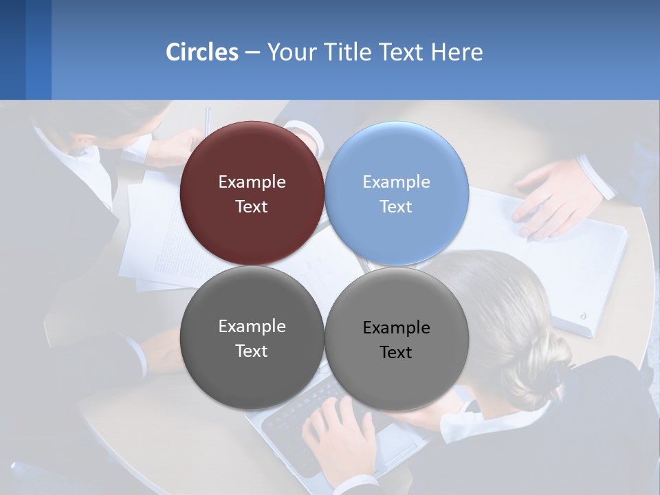 A Group Of People Sitting Around A Table Working On A Laptop PowerPoint Template