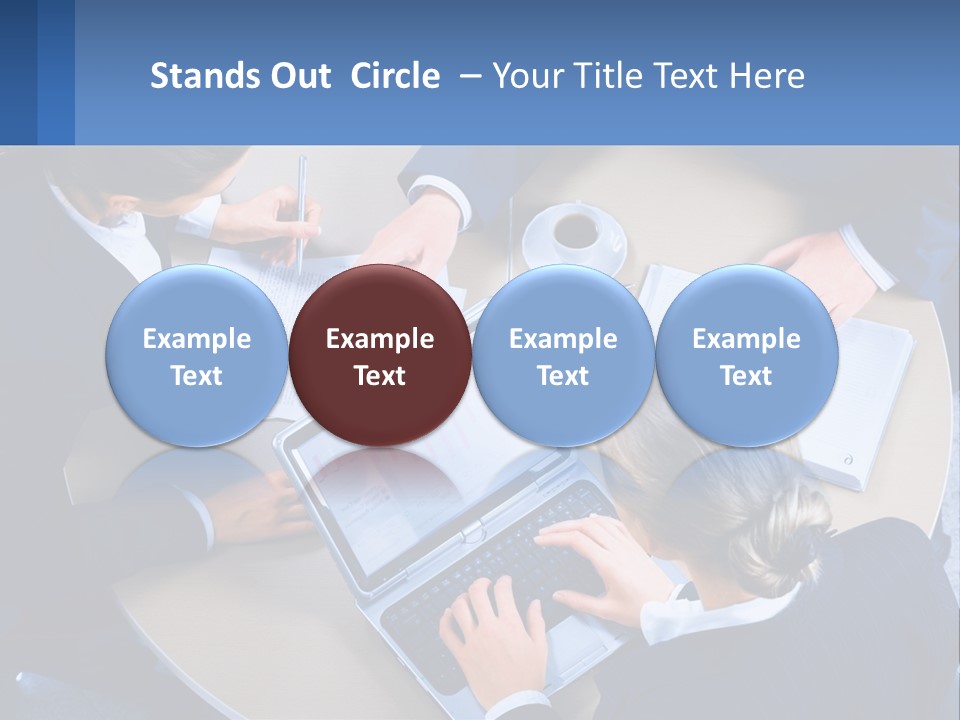 A Group Of People Sitting Around A Table Working On A Laptop PowerPoint Template