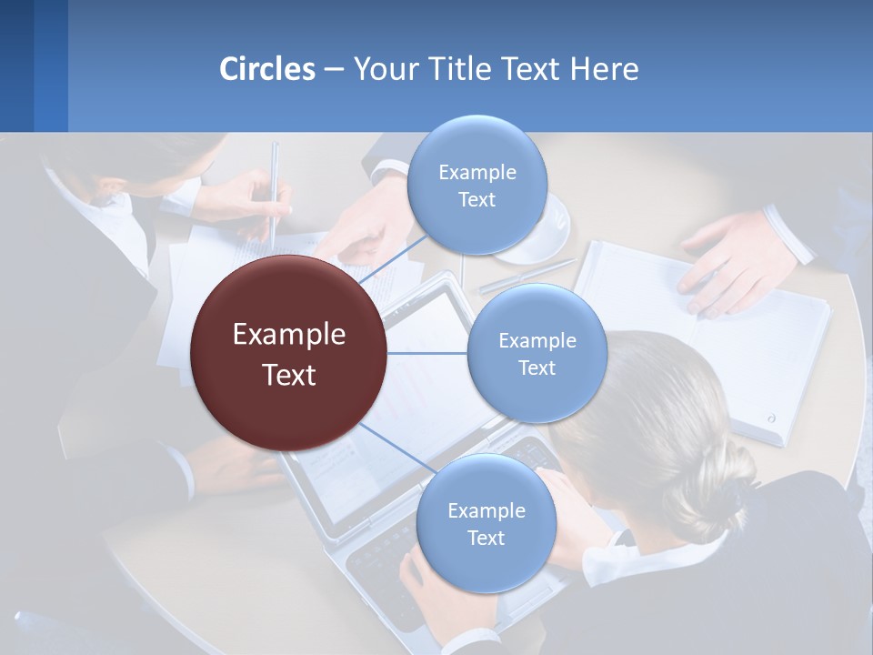 A Group Of People Sitting Around A Table Working On A Laptop PowerPoint Template