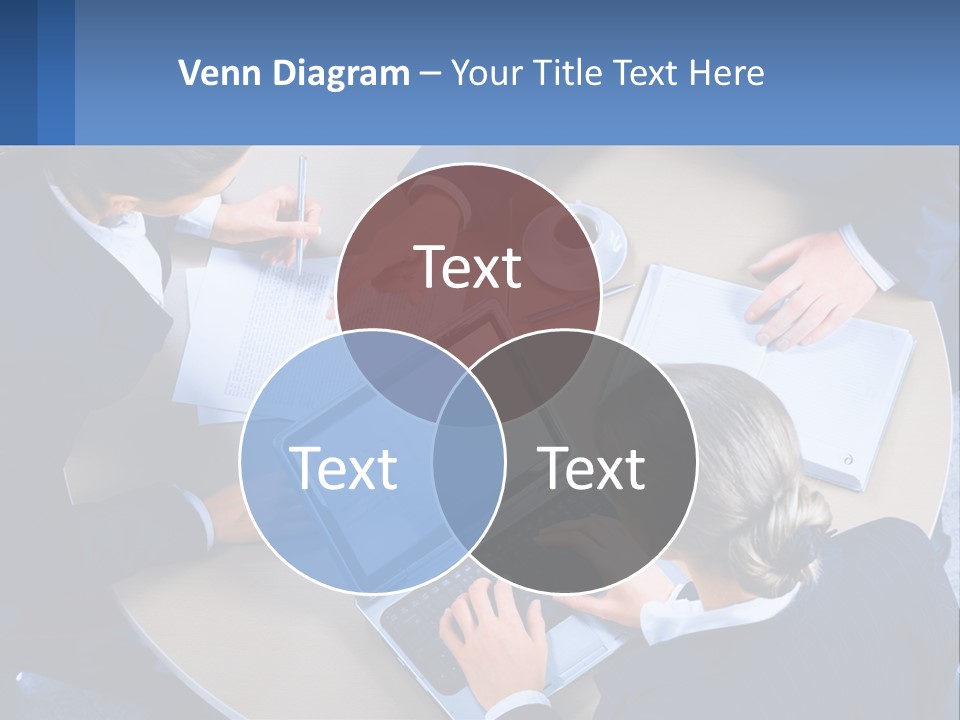 A Group Of People Sitting Around A Table Working On A Laptop PowerPoint Template