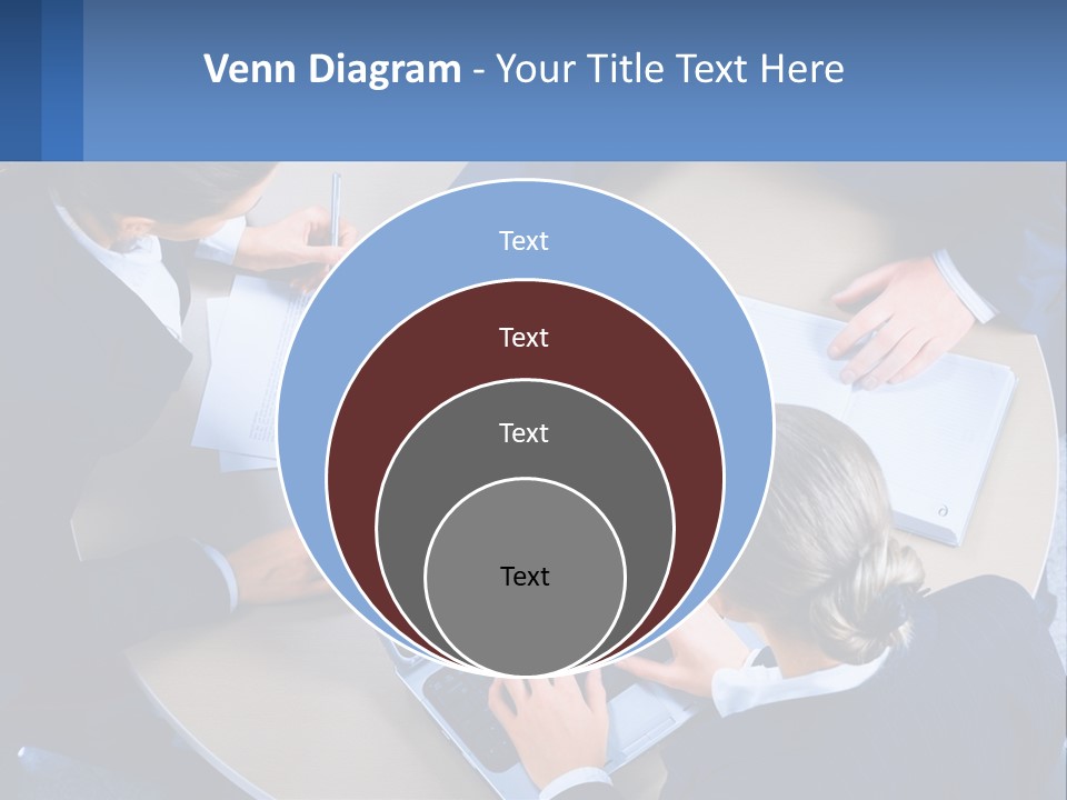 A Group Of People Sitting Around A Table Working On A Laptop PowerPoint Template