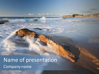 A Rocky Beach With Waves Crashing On It PowerPoint Template
