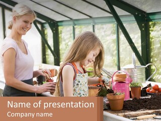 A Woman And A Little Girl Are In A Greenhouse PowerPoint Template