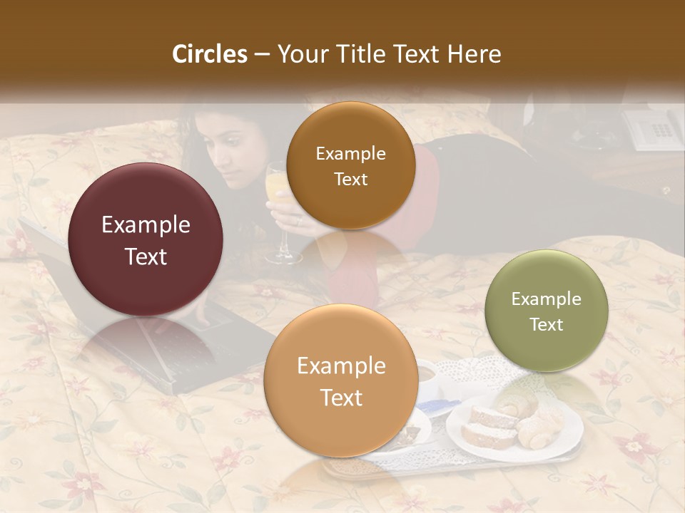 A Woman Laying On A Bed With A Laptop And A Glass Of Orange Juice PowerPoint Template