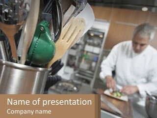 A Man In A Kitchen Preparing Food On A Plate PowerPoint Template
