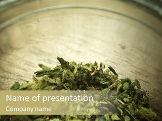 A Metal Bowl Filled With Green Leaves On Top Of A Table PowerPoint Template