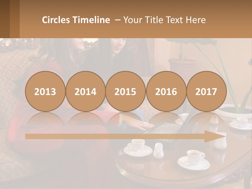 Two Women Sitting On A Couch Looking At A Laptop PowerPoint Template