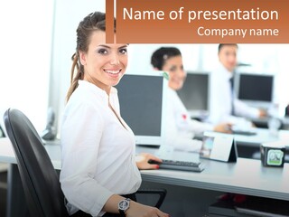 A Woman Sitting At A Desk In An Office PowerPoint Template