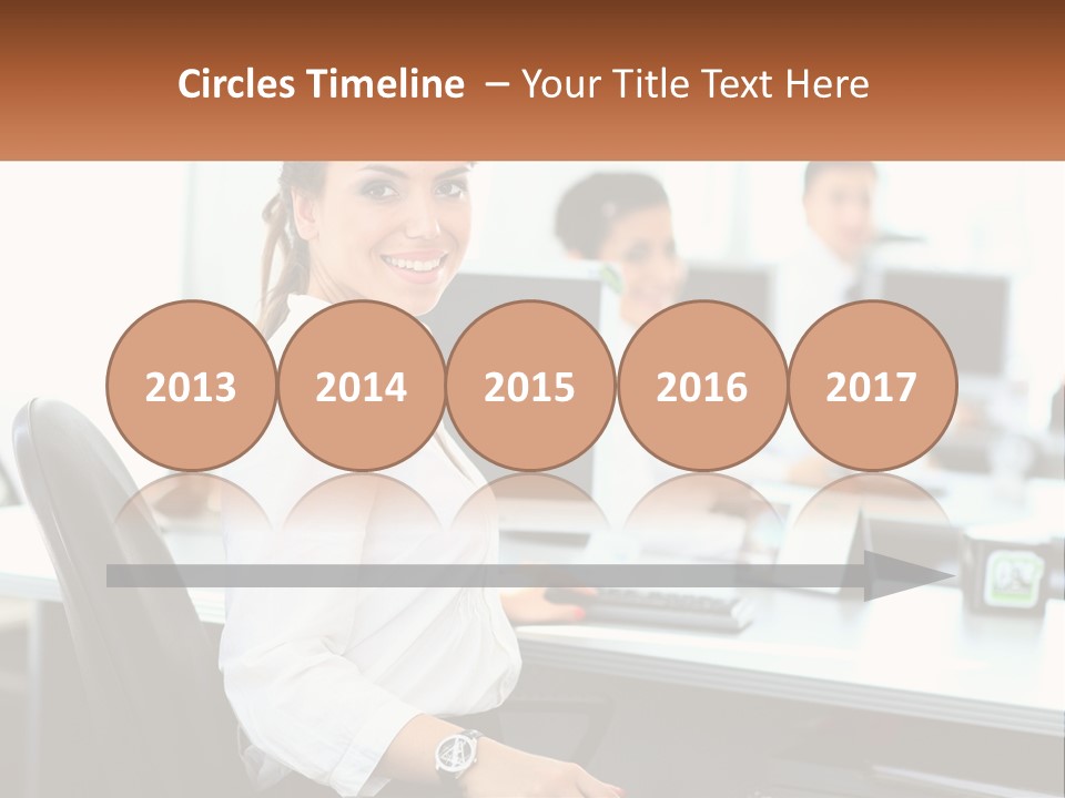 A Woman Sitting At A Desk In An Office PowerPoint Template