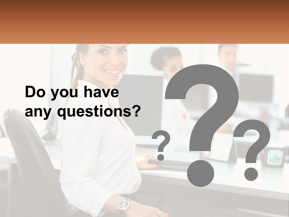 A Woman Sitting At A Desk In An Office PowerPoint Template