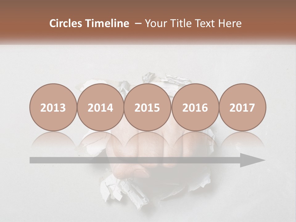 A Fist Punching Through A Piece Of Paper PowerPoint Template