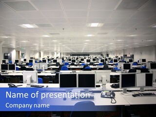 A Room Full Of Computer Monitors And Keyboards PowerPoint Template