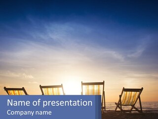 Two Chairs Sitting On A Beach With The Sun Setting In The Background PowerPoint Template