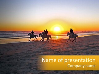 A Group Of People Riding Horses On A Beach At Sunset PowerPoint Template