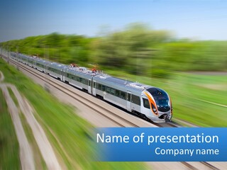 A Train Traveling Down A Track With Trees In The Background PowerPoint Template