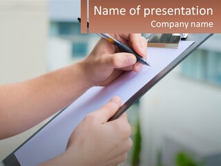 A Person Writing On A Piece Of Paper With A Pen PowerPoint Template